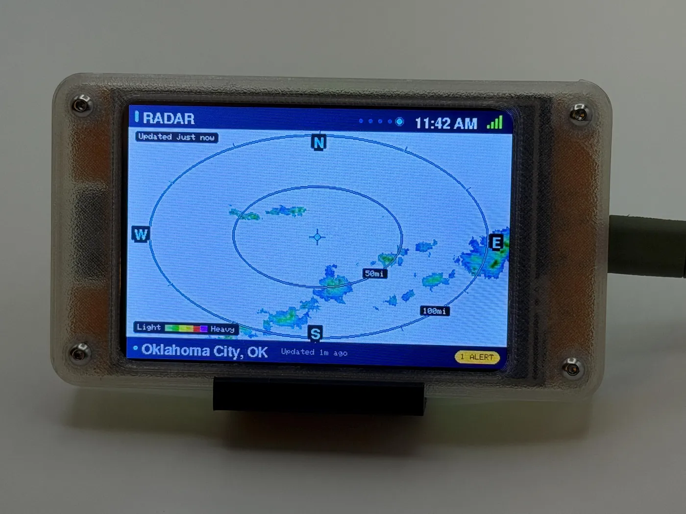 Live regional radar screen with distance rings and precipitation