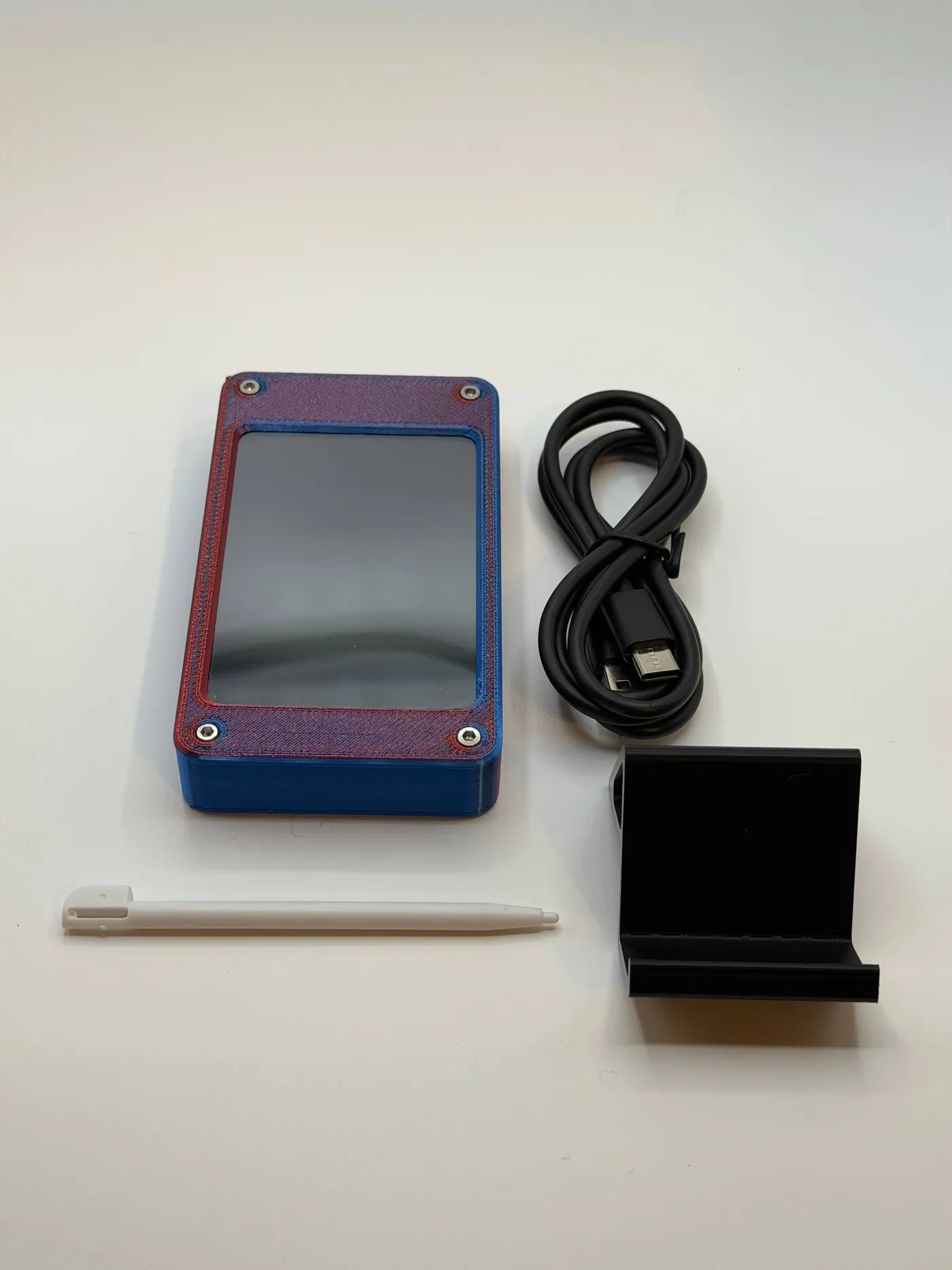 What’s in the box: Seismic Sentinel in its Hyper Red/Blue enclosure, a black desktop stand, a USB-C cable and a white stylus