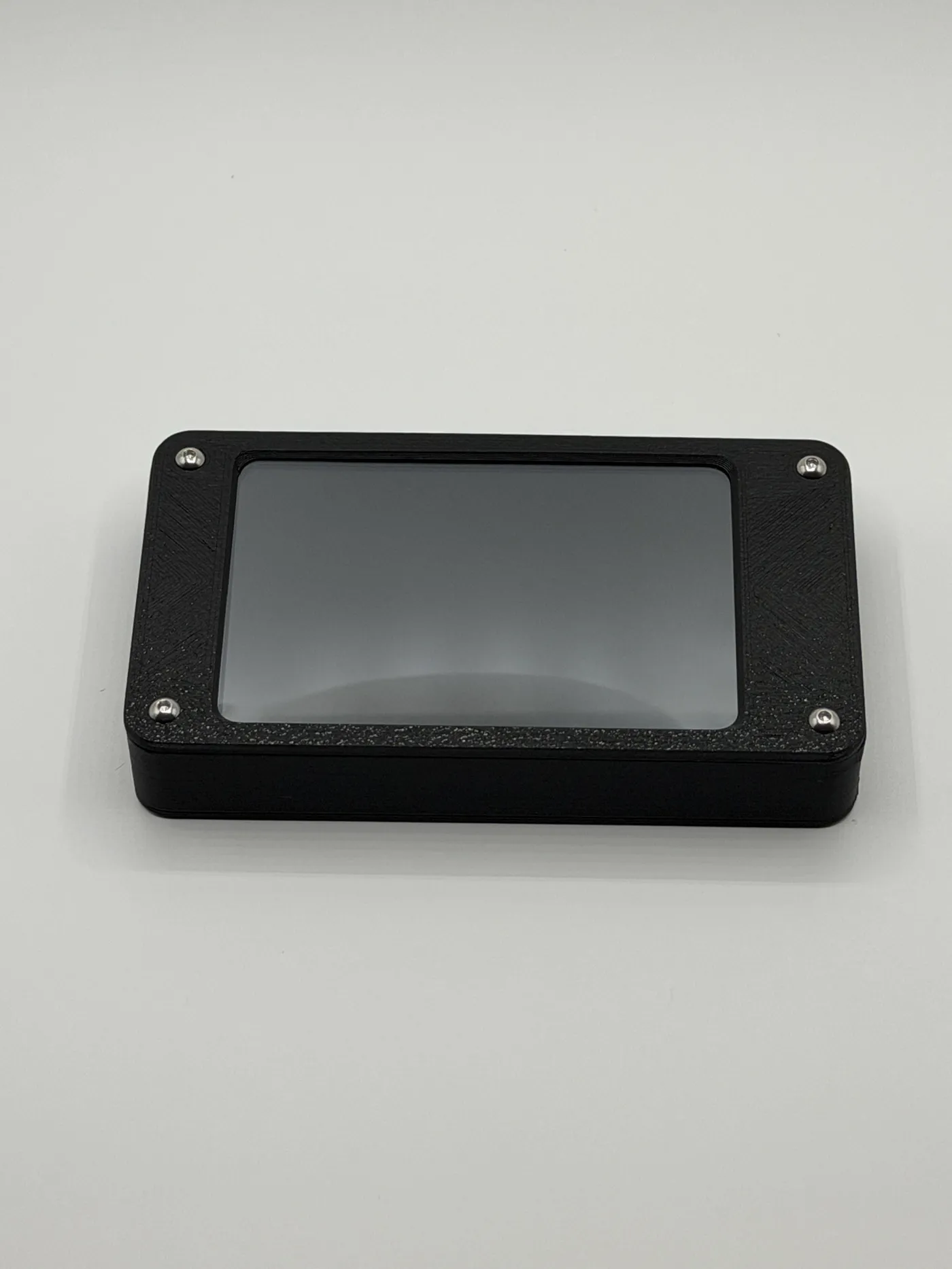 Front view of the black enclosure with silver corner screws